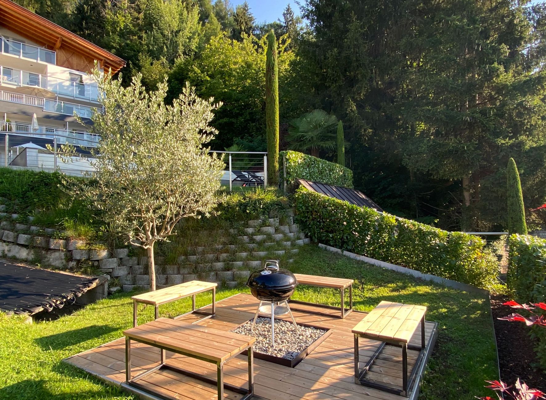 Barbecue area with seating in the garden Garden Residence Lechner barbecue grill